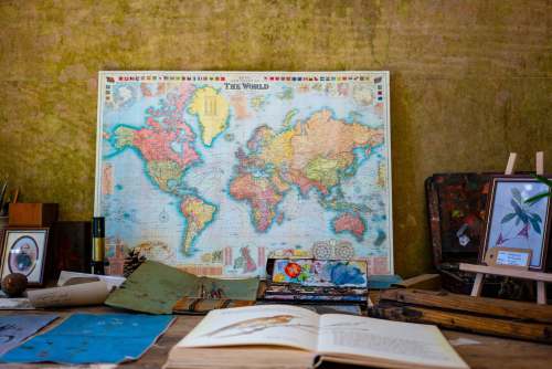 united kingdom world map poster near book and easel art